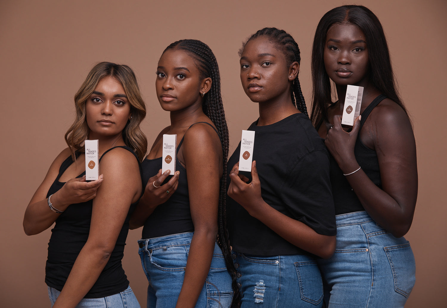 4 women of colour holding The MATTERfying Foundation for deeper skintones 